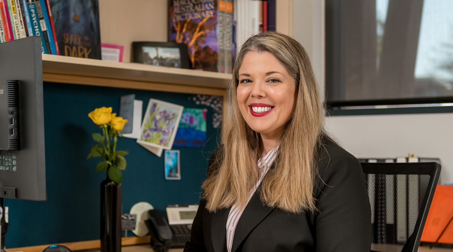 Photo of Mrs Emily Goforth Tranby Principal, sitting at her desk in her office at Tranby College