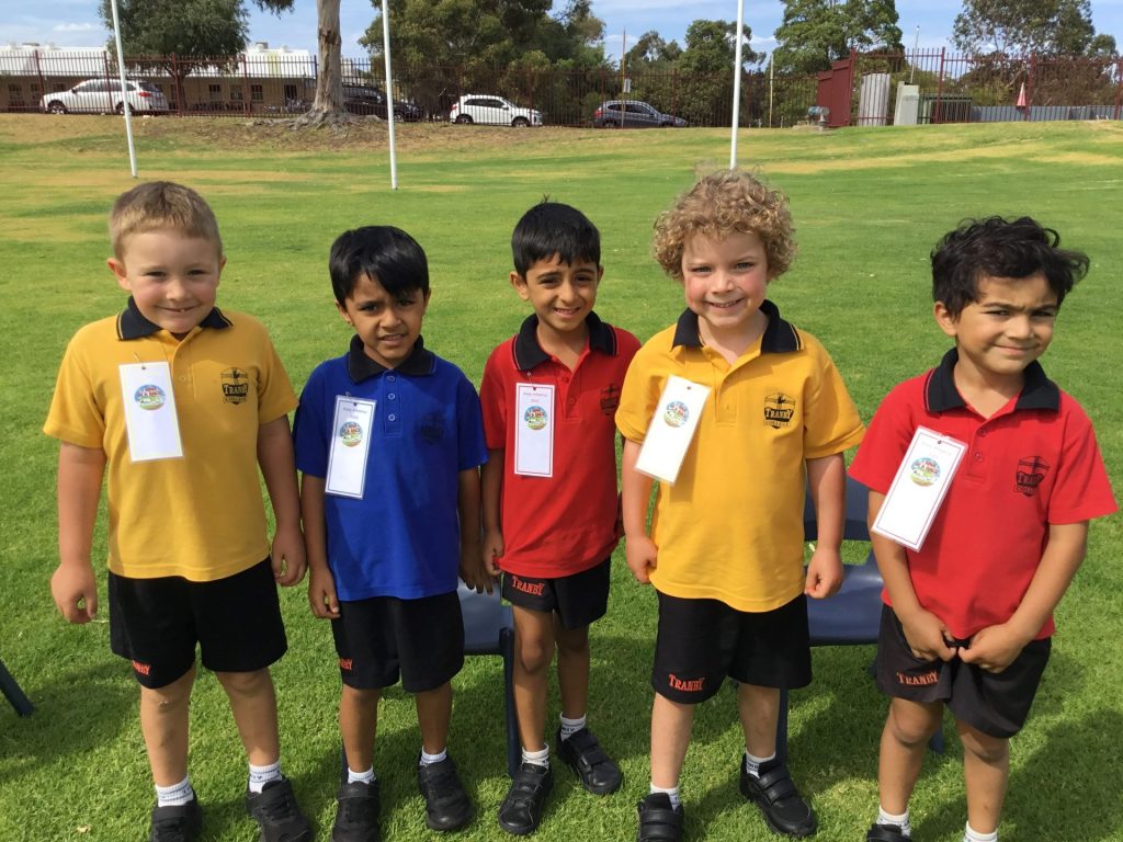 Kindy children showing off their athletics winning badges jn 2023