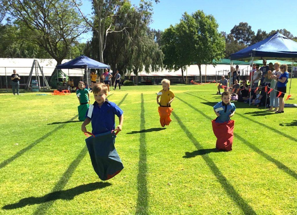 Kindy children competing in a sack race jn 2023