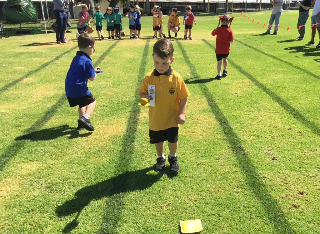 Kindy children competing in an egg and spoon race jn 2023