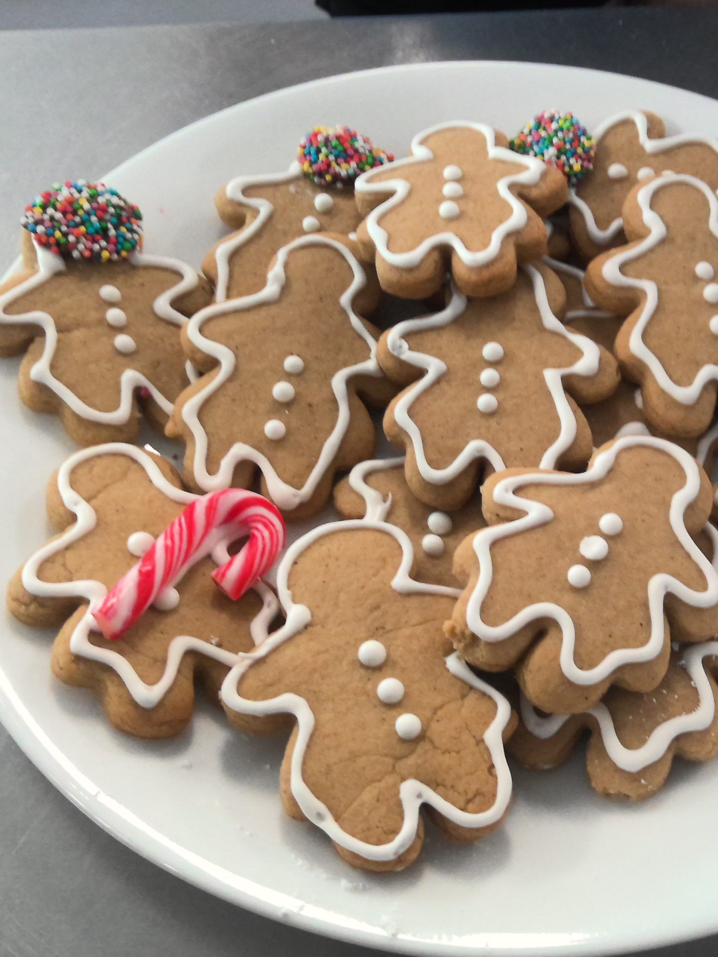 A photo of gingerbread people and a candy cane.